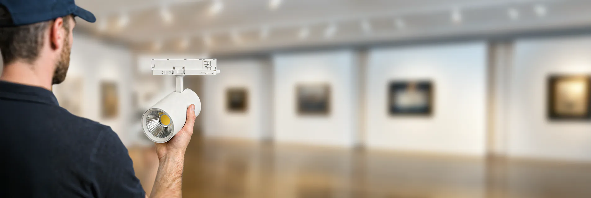 Mann h&auml;lt einen Noxion Schienenstrahler in einem Museum in der Hand. 